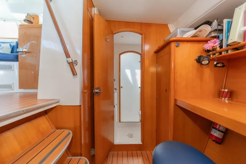 Slide: The Image of Interior of 2004 Lagoon 380 catamaran with wooden cabinetry and seating area. - 61