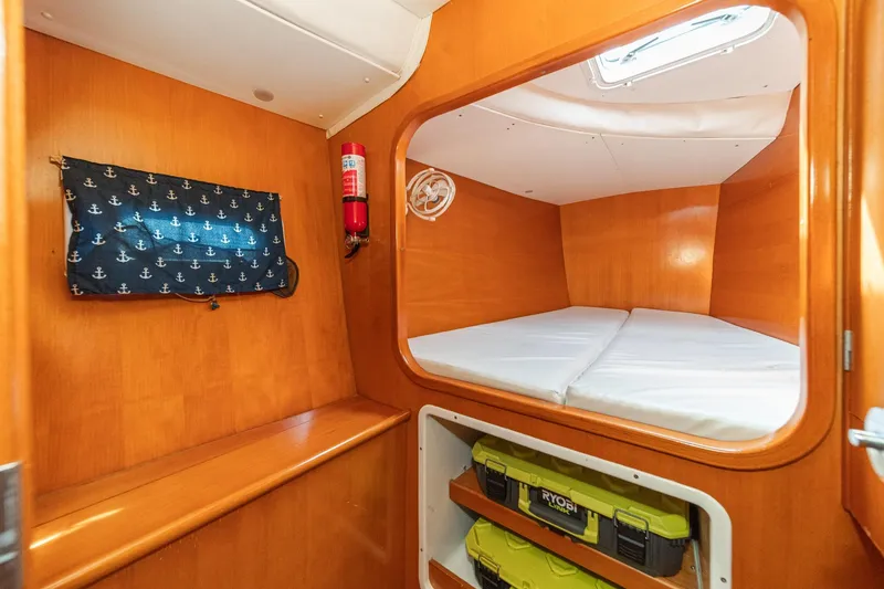 Slide: The Image of Interior cabin of 2004 Lagoon 380 catamaran with wooden finish and storage space. - 66