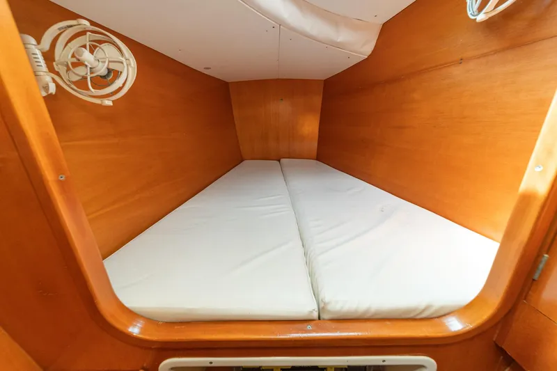 Slide: The Image of Interior cabin of 2004 Lagoon 380 catamaran with wooden finish and white mattress. - 67