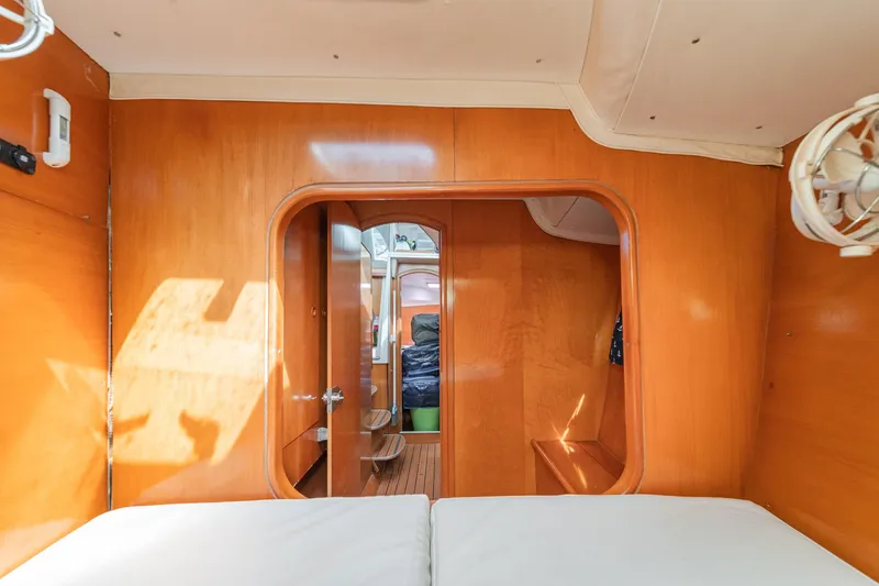 Slide: The Image of Interior cabin of 2004 Lagoon 380 catamaran with wooden finish and cozy bedding. - 68