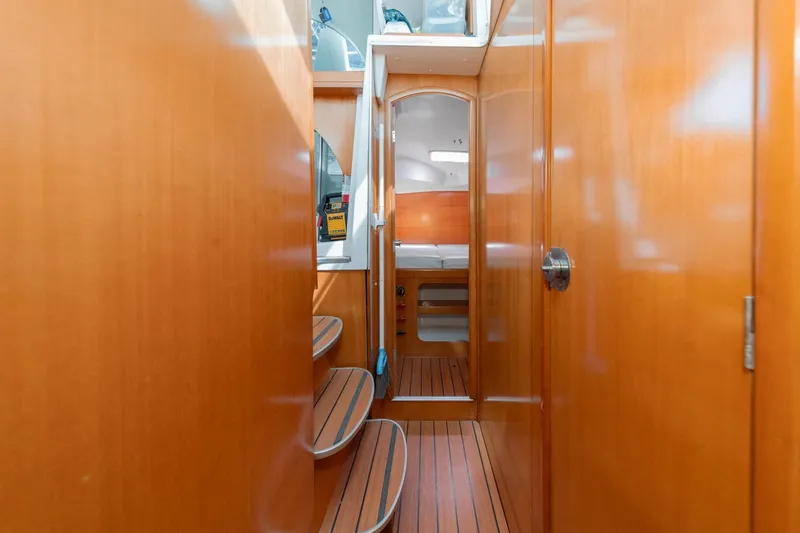 Slide: The Image of Interior view of 2004 Lagoon 380 catamaran with wooden finish and cozy cabin. - 69