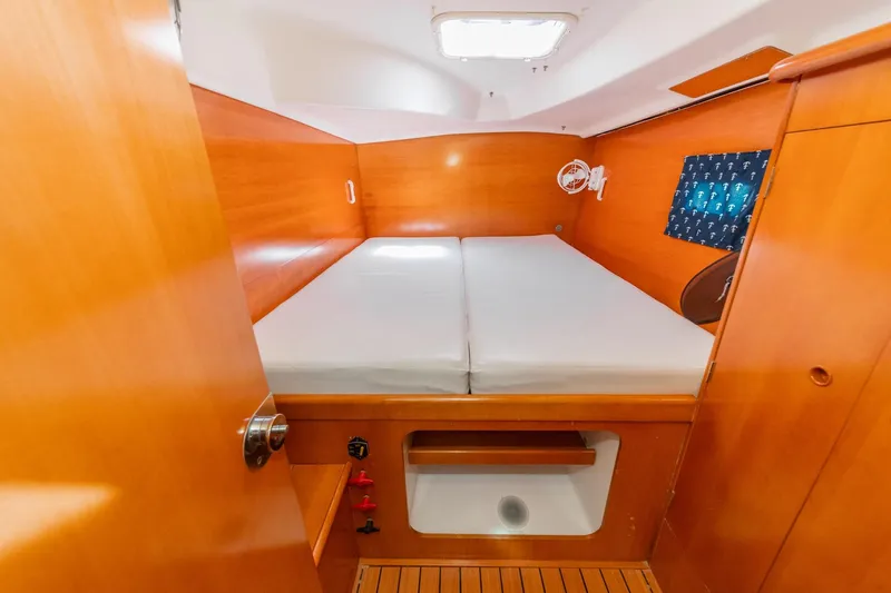 Slide: The Image of Cozy cabin interior of 2004 Lagoon 380 catamaran with wooden finish and double bed. - 70