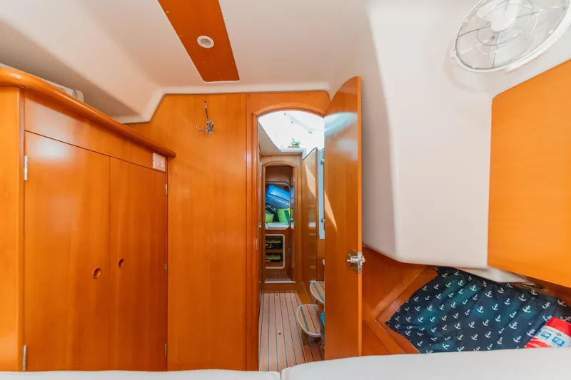 Slide: The Image of Interior of a 2004 Lagoon 380 catamaran with wooden cabinetry and nautical decor. - 71