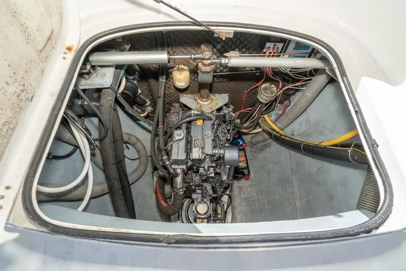 Slide: The Image of Engine compartment of a 2004 Lagoon 380 catamaran, showing mechanical components and wiring. - 73