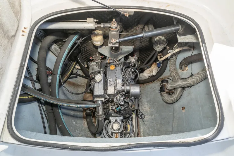 Slide: The Image of Engine compartment of a 2004 Lagoon 380 catamaran, showcasing mechanical components and hoses. - 75