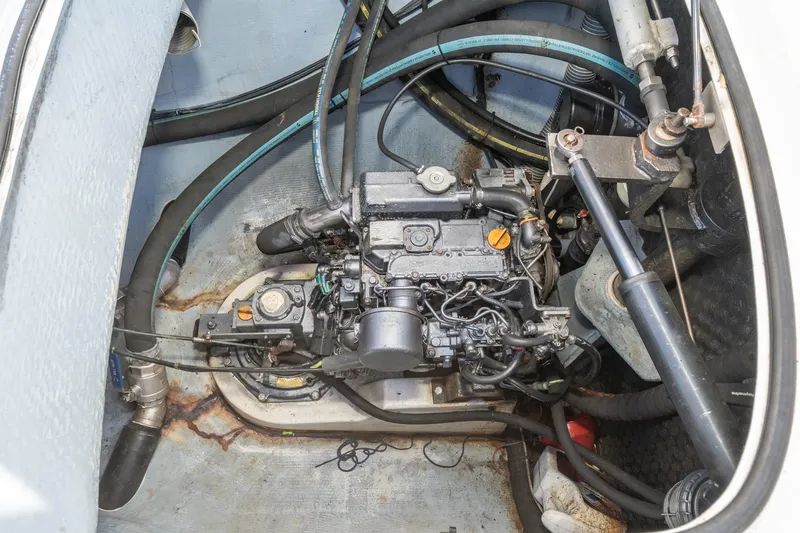Slide: The Image of Engine compartment of a 2004 Lagoon 380 catamaran, showcasing mechanical components and hoses. - 76