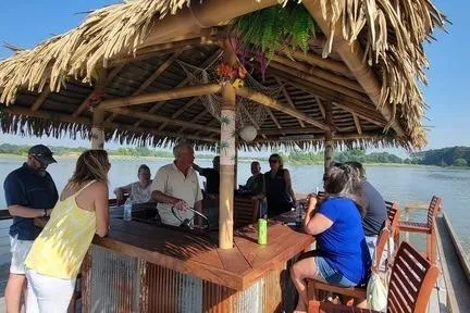 Slide: The Image of People enjoying a sunny day under a thatched roof on a Big Hut 26 boat, 2023. - 2
