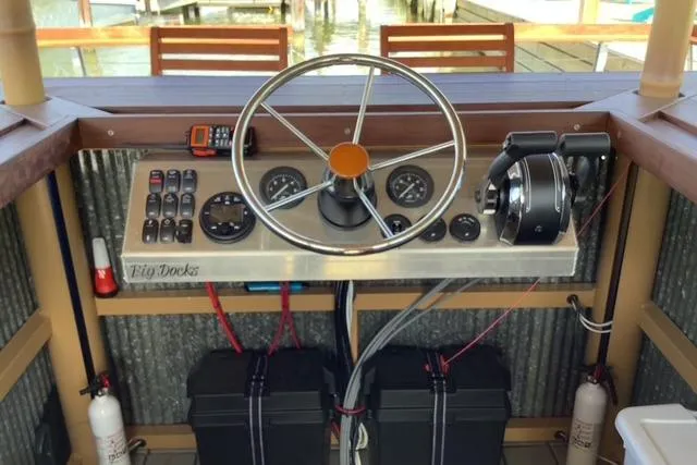 Slide: The Image of Steering console of a 2023 Big Hut 26 boat with gauges and controls. - 3