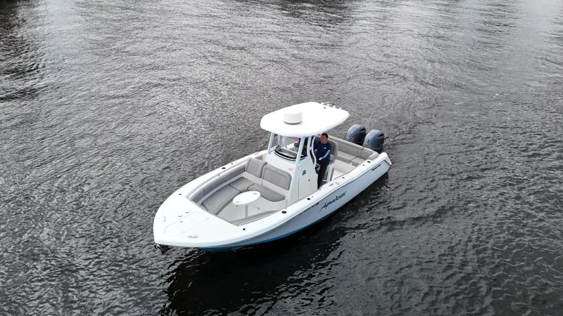 Slide: The Image of 2017 Tidewater 252 LXF boat on water, featuring dual engines and spacious seating. - 1