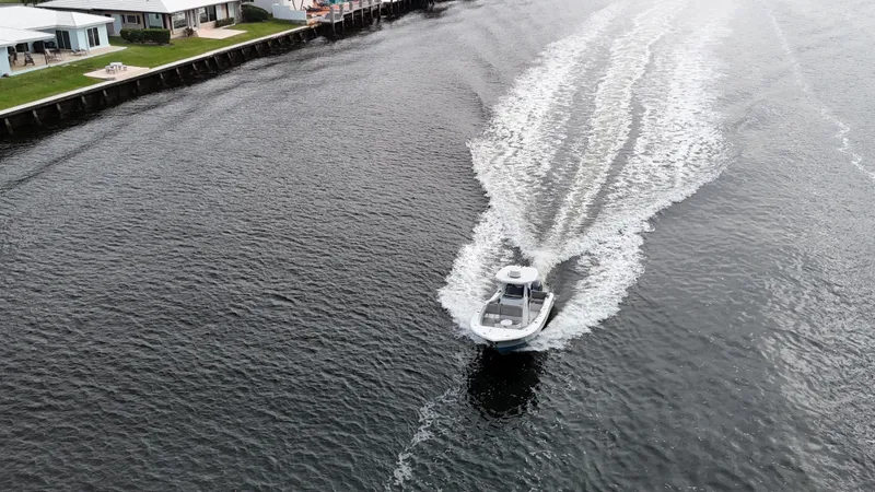 Slide: The Image of Aerial view of 2017 Tidewater 252 LXF boat cruising on a waterway. - 15