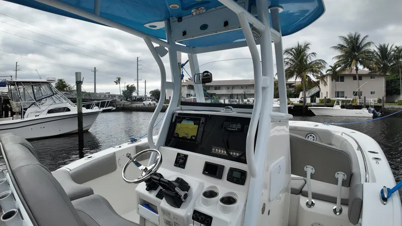 Slide: The Image of 2017 Tidewater 252 LXF boat interior with steering wheel and navigation system. - 19