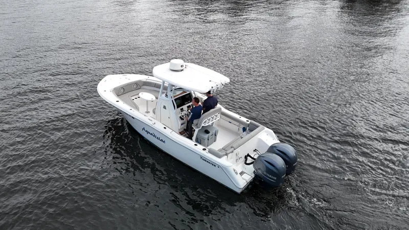 Slide: The Image of 2017 Tidewater 252 LXF boat on water with dual engines. - 2