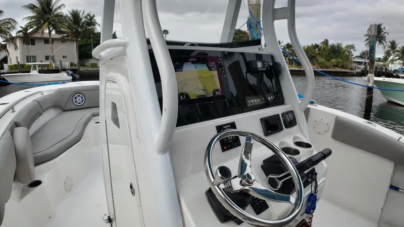 Slide: The Image of 2017 Tidewater 252 LXF boat cockpit with steering wheel and navigation system. - 21