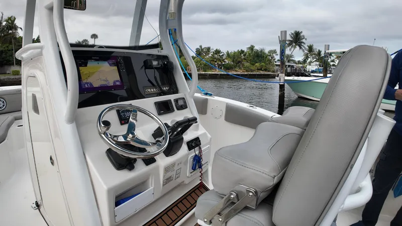 Slide: The Image of 2017 Tidewater 252 LXF boat cockpit with steering wheel and navigation system. - 23