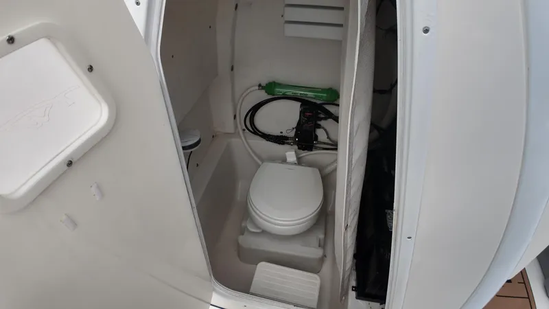 Slide: The Image of 2017 Tidewater 252 LXF boat interior bathroom with toilet and storage. - 27