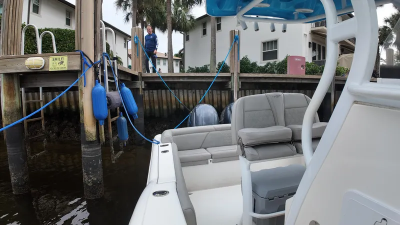 Slide: The Image of Tidewater 252 LXF boat docked near waterfront homes, 2017 model. - 29