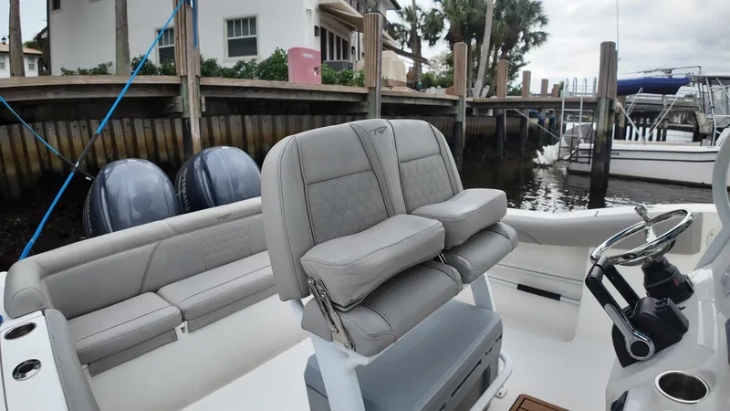 Slide: The Image of 2017 Tidewater 252 LXF boat interior with dual engines and plush seating. - 32