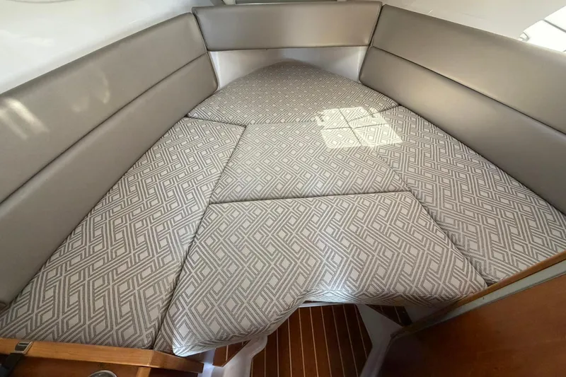 Slide: The Image of 2019 Cutwater C-28 cabin interior with patterned cushions and sleek design. - 13
