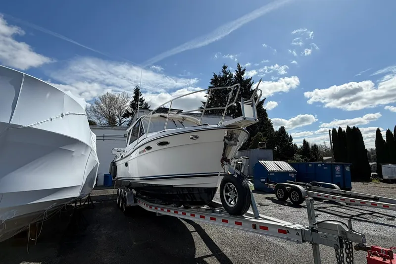 Slide: The Image of 2019 Cutwater C-28 boat on trailer under clear blue sky. - 2