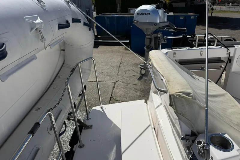 Slide: The Image of 2019 Cutwater C-28 boat with Honda outboard motor and inflatable dinghy on deck. - 3