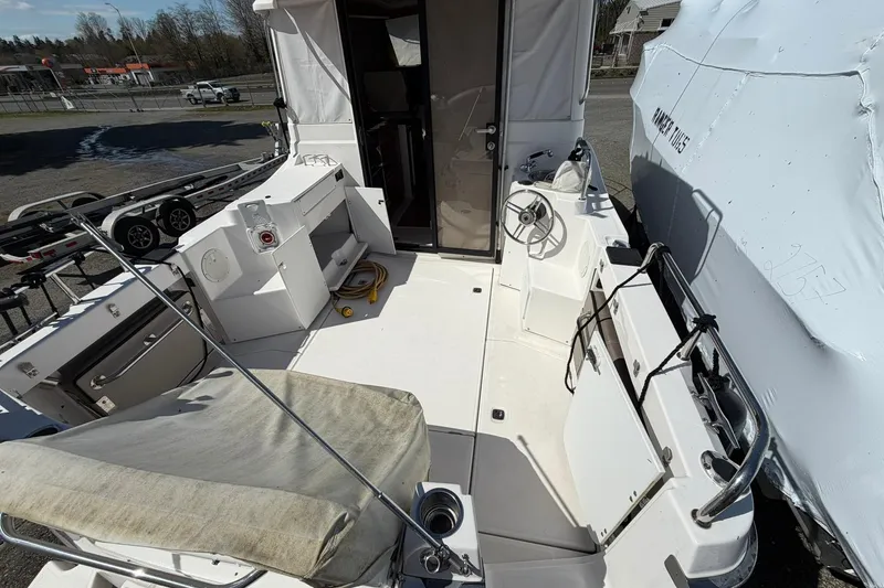 Slide: The Image of 2019 Cutwater C-28 boat deck with seating, steering wheel, and storage compartments. - 4