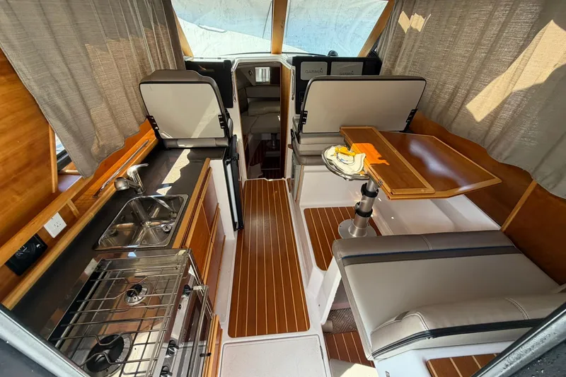 Slide: The Image of Interior of a 2019 Cutwater C-28 boat with kitchen and seating area. - 5