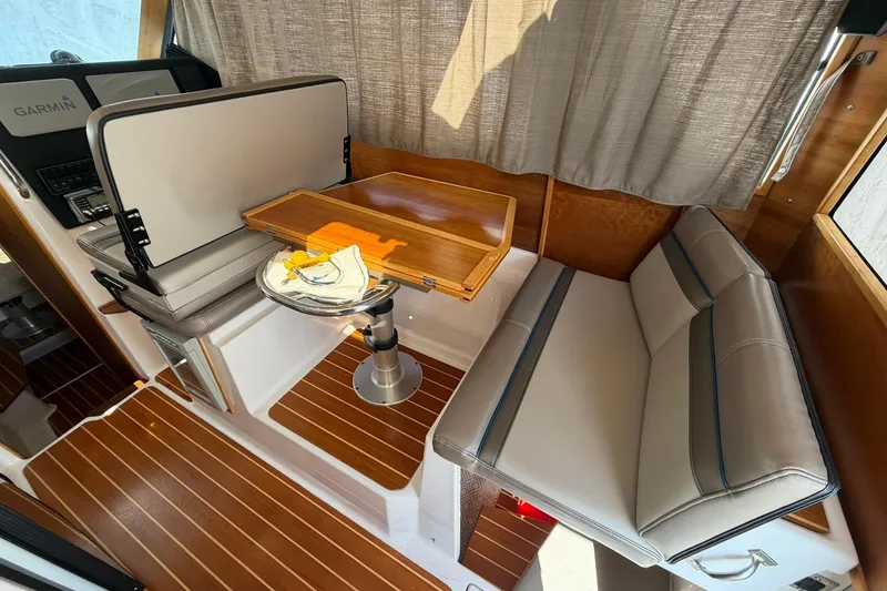 Slide: The Image of Interior of 2019 Cutwater C-28 boat with seating, table, and Garmin navigation system. - 7