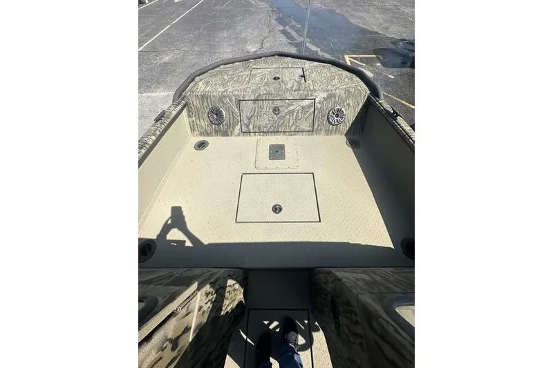 Slide: The Image of 2025 SeaArk Predator 300 AK boat interior with camouflage design and storage compartments. - 11