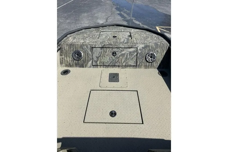 Slide: The Image of 2025 SeaArk Predator 300 AK boat deck with storage compartments and speakers. - 6