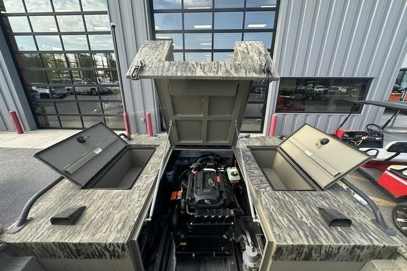 Slide: The Image of 2025 SeaArk Predator 300 AK boat engine compartment with open hatches, showcasing interior details. - 8