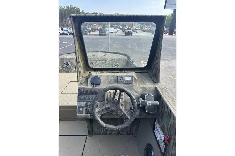 Slide: The Image of 2025 SeaArk Predator 300 AK boat dashboard with steering wheel and controls. - 9
