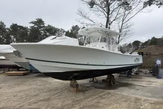 The Image of 2009 Regulator 32 Forward Seating boat on dry dock, side view. - 3