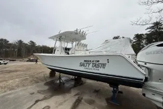Slide: The Image of 2009 Regulator 32 Forward Seating boat on dry land with twin Suzuki engines. - 6