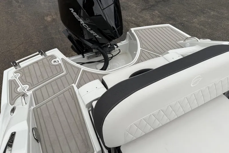 Slide: The Image of 2024 Crownline Eclipse E240 XS boat with Mercury engine and stylish seating. - 2