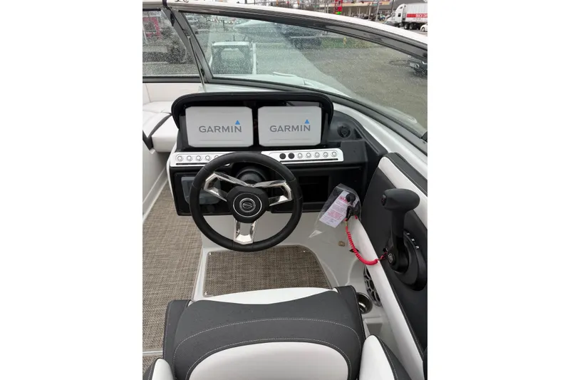 Slide: The Image of 2024 Crownline Eclipse E240 XS boat dashboard with Garmin navigation displays. - 7