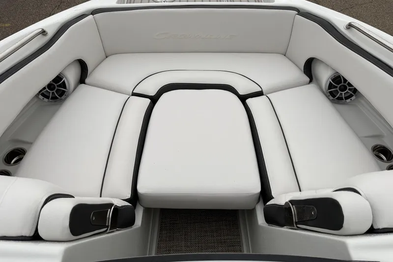 Slide: The Image of 2024 Crownline Eclipse E240 XS boat interior with white cushioned seating and speakers. - 8