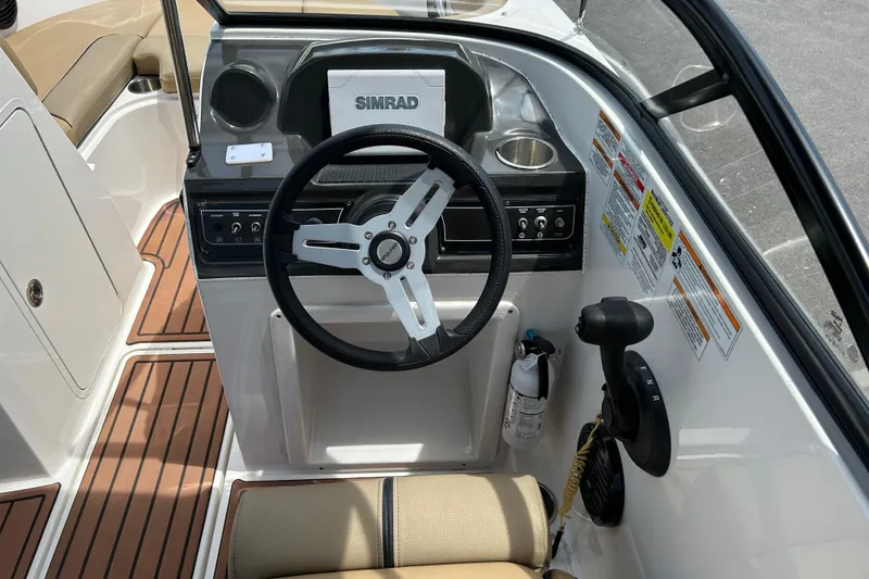 Slide: The Image of 2023 Bayliner VR4 Bowrider OB cockpit with steering wheel and control panel. - 10