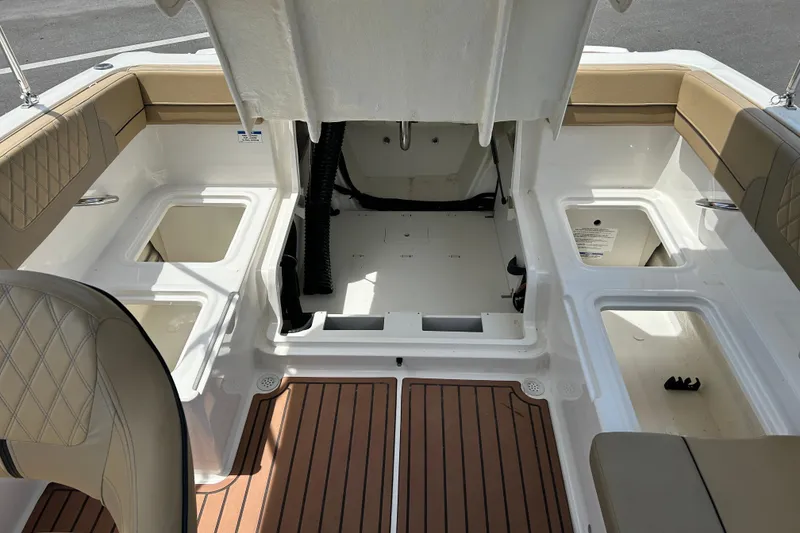 Slide: The Image of 2023 Bayliner VR4 Bowrider OB interior with tan seating and storage compartments. - 15