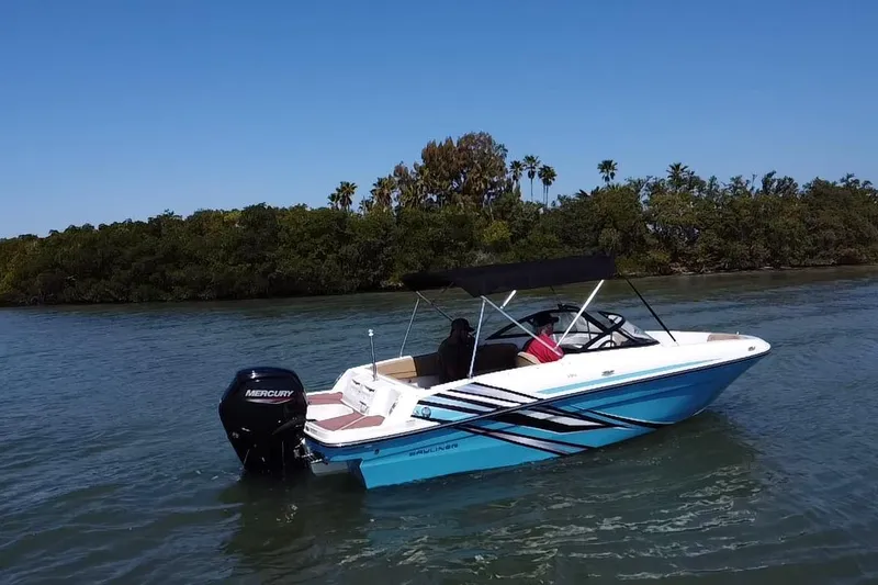 Slide: The Image of 2023 Bayliner VR4 Bowrider OB on calm water, featuring sleek design and Mercury outboard motor. - 19