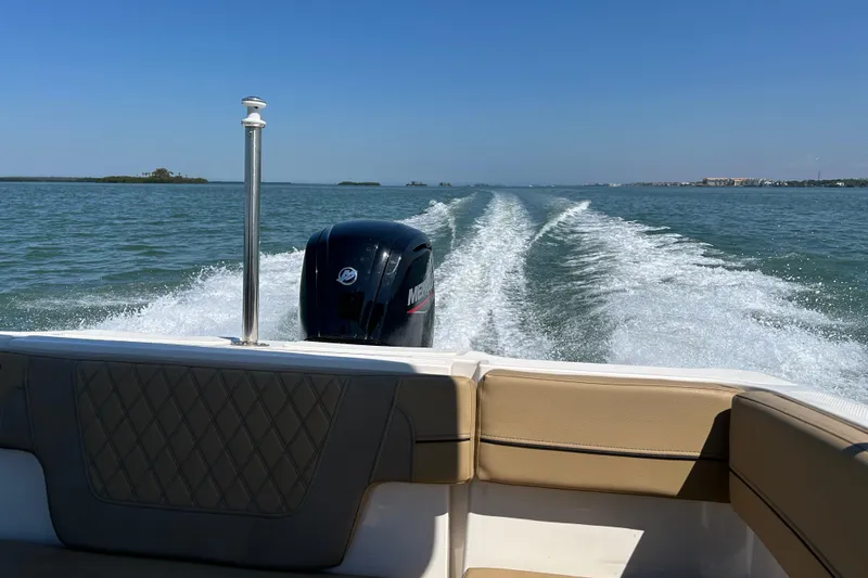 Slide: The Image of 2023 Bayliner VR4 Bowrider OB cruising on open water, leaving a wake behind. - 20