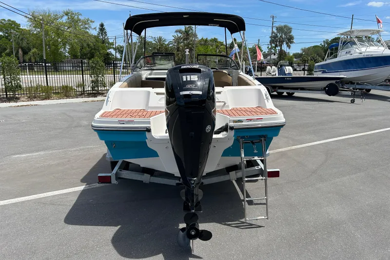 Slide: The Image of 2023 Bayliner VR4 Bowrider OB with Mercury 115 engine, parked on a sunny day. - 3