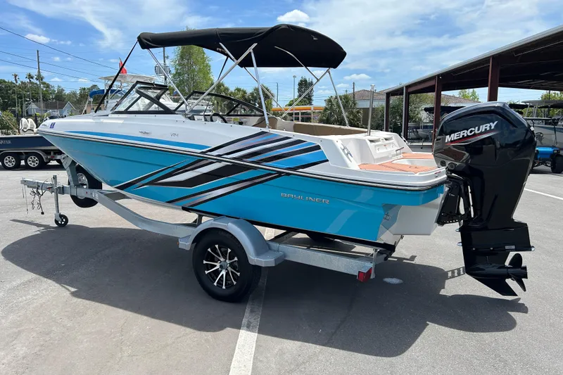 Slide: The Image of 2023 Bayliner VR4 Bowrider OB with Mercury outboard engine on trailer, blue and white design. - 4