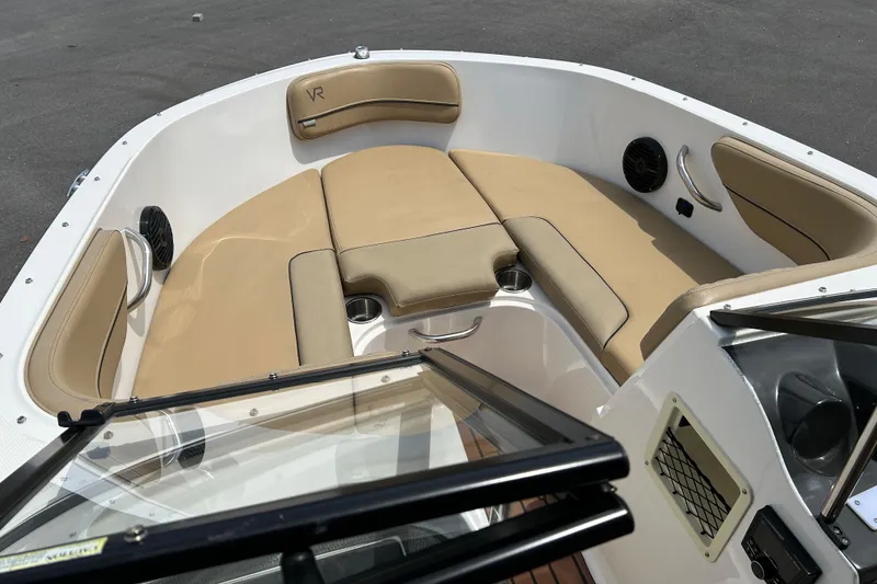 Slide: The Image of 2023 Bayliner VR4 Bowrider OB interior with tan seating and cup holders. - 8