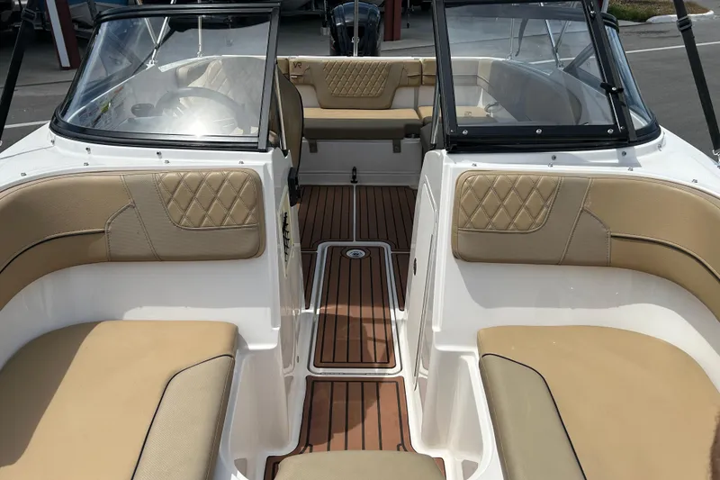 Slide: The Image of 2023 Bayliner VR4 Bowrider OB interior with tan seating and wood-style flooring. - 9