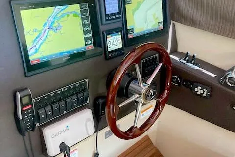 Slide: The Image of 2018 Cutwater C-30 Sedan helm with navigation screens and wooden steering wheel. - 15