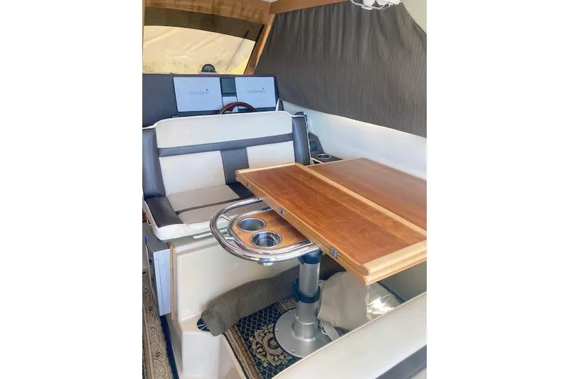 Slide: The Image of Interior of 2018 Cutwater C-30 Sedan with wooden table and cushioned seating. - 17