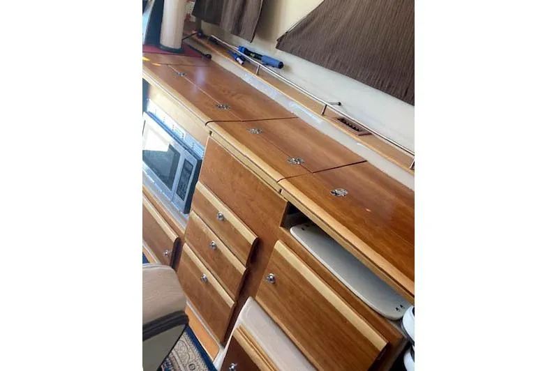 Slide: The Image of Interior view of 2018 Cutwater C-30 Sedan with wooden cabinetry and built-in microwave. - 20