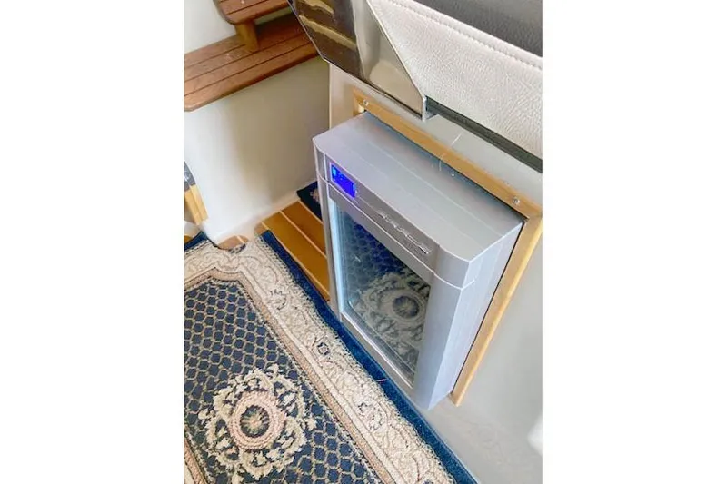 Slide: The Image of Compact refrigerator in 2018 Cutwater C-30 Sedan boat interior, featuring a patterned carpet. - 23