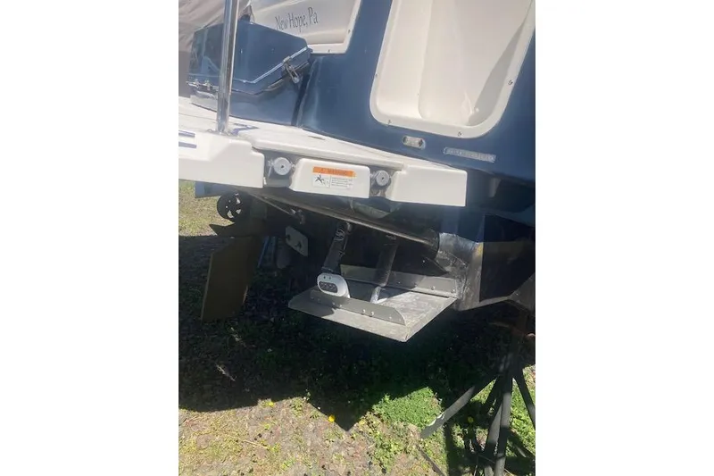 Slide: The Image of 2018 Cutwater C-30 Sedan boat stern view with visible propeller and trim tabs. - 29