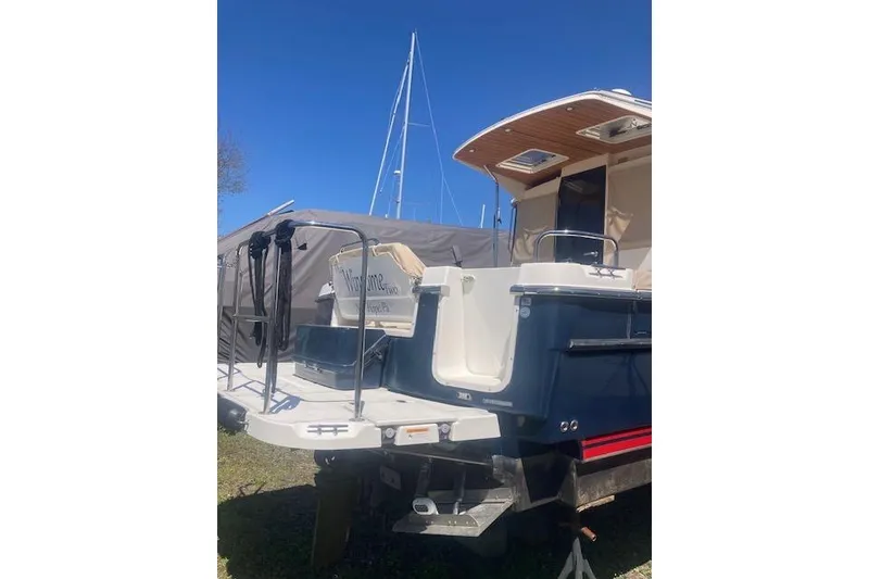 Slide: The Image of 2018 Cutwater C-30 Sedan boat docked, featuring a spacious deck and sleek design. - 4
